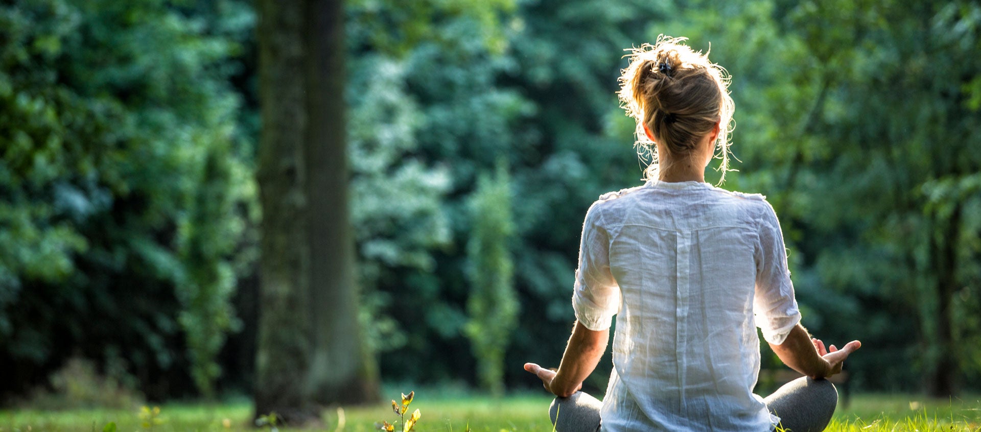 woman in white shirt meditating